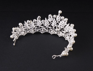 Detailed top view of silver bridal crown featuring pearls and intricate leaf rhinestones