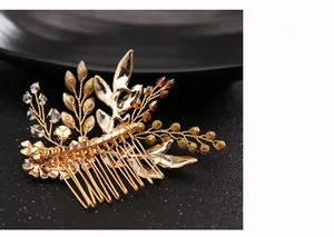 Detail shot of golden bridal hair comb featuring crystal beads and leaf design