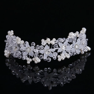 Detail view of handmade bridal hairband with crystal flowers and white faux pearls
