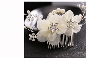 Detail of bridal hair comb with cream chiffon flowers and rhinestone star accents