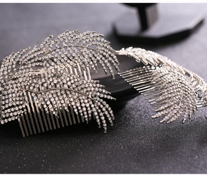Close-up of sparkling rhinestone feather bridal hair combs with silver alloy finish