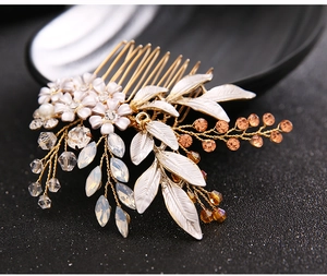 Macro shot of bridal hair comb with white flowers, amber beads and crystals on black background