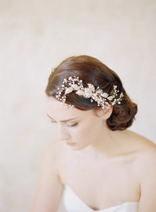 Close-up of golden leaf bridal hair comb with pearls and crystals in a Baroque style