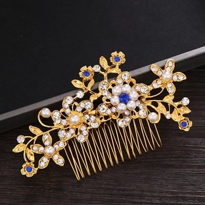 Detailed close-up of a vintage bridal hair comb with pearls, crystals, and blue gemstones