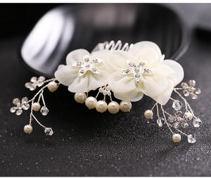 Detail of cream bridal hair comb with chiffon flowers, crystals and silver rhinestones