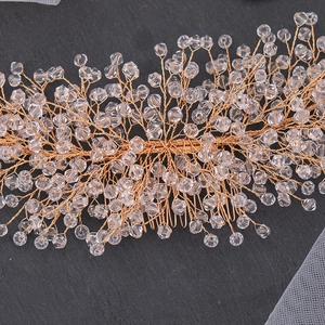 Macro detail of rose gold bridal hair comb with handmade crystal beads and wire branches