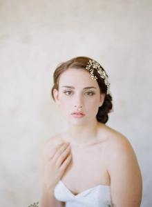 Detail of bridal hair comb with pearls and rhinestones on a white model's side hair