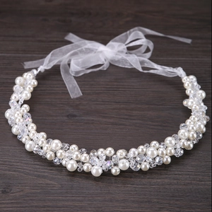 Handmade bridal headband with white pearls and clear crystals on a silver wire