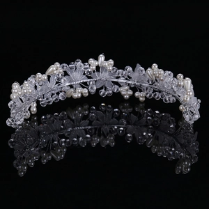 Macro shot of bridal hairband with crystal flowers and pearls on a black background