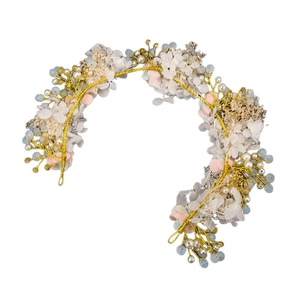 Handmade bridal floral headband with gold wire, pink flowers, and pearls on white backdrop