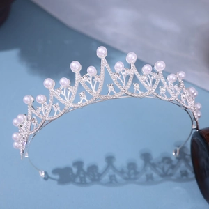 Elegant bridal tiara with pearls and rhinestones on a silver metal frame for weddings