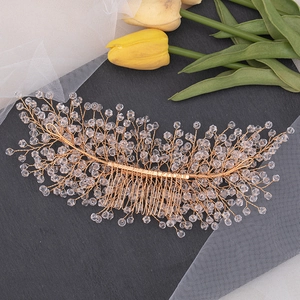 Detail showing the intricate hand-woven golden wire and crystal beads of the bridal hair comb
