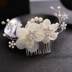 Elegant bridal hair comb featuring cream fabric flowers, sparkling rhinestones and pearls
