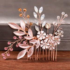 Elegant rose gold bridal hair comb with pink flowers, crystals, and pearls for weddings