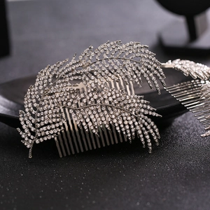 Silver bridal hair comb featuring elegant rhinestone feather designs for wedding hairstyles