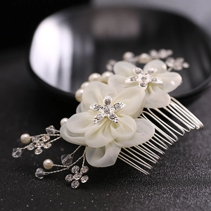 Exquisite bridal hair comb with ivory fabric flowers, pearls, and rhinestones for weddings