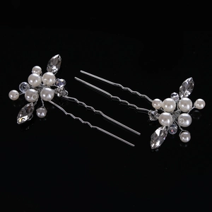 Detail of silver U-shaped hair pins with white pearls and sparkling crystal flowers