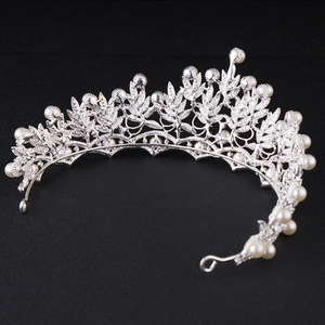 Elegant silver bridal crown with leaf design and white pearls on black background