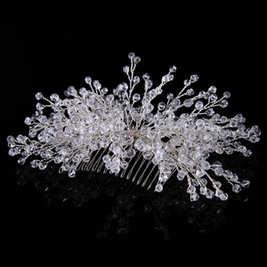 Detailed view of bridal hair comb with silver wire weaving and crystal beads on black background