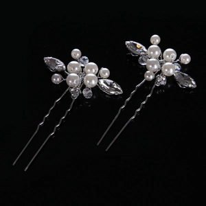 Detail of two handmade bridal hair pins with white pearls and sparkling rhinestones