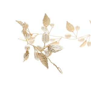 Detailed view of handmade bridal headband with golden leaves and white pearls