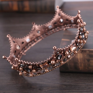 Macro detail of vintage baroque crown with antique bronze metal and dark gemstones