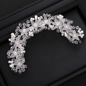 Detail of handcrafted bridal hair vine with white matte flowers, pearls, and crystals