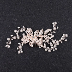 Baroque rose gold bridal hair comb featuring delicate pearls, rhinestones and leaf accents