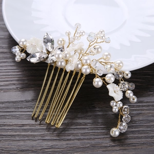 Handmade bridal hair comb with pearls and gold floral accents for elegant wedding styling
