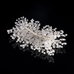 Detail of handmade silver bridal hair comb with faceted crystals for wedding hairstyles