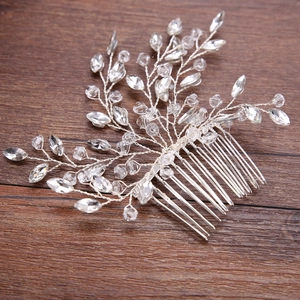 Close-up of bridal hair comb with silver wire and faceted crystal glass beads