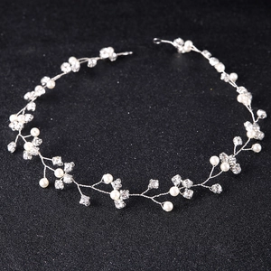 Elegant bridal hair vine with white pearls and sparkling rhinestones on silver wire