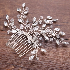 Detailed view of handmade silver bridal hair comb with crystal vine branch design
