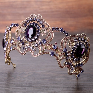 Close-up of vintage bronze crown with purple rhinestones and crystal gemstone details