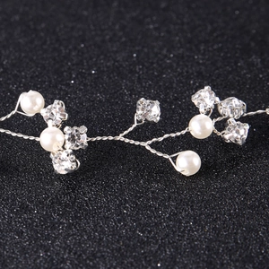Macro detail of handmade bridal headband with pearls and sparkling rhinestones