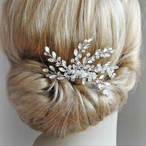 Rear view of bridal crystal hair comb with silver leaf and bead details on blonde hair