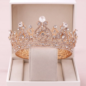 Detail shot of golden vintage bridal crown with sparkling heart pattern and rhinestones