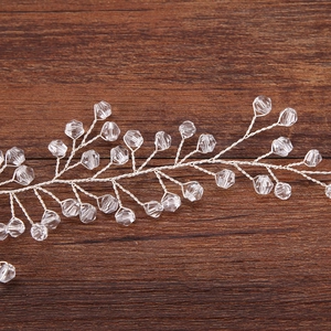 Silver vine hairband with sparkling crystal beads on a rustic wooden background