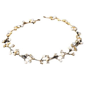 Elegant bridal hair band with white pearls and sparkling rhinestones on golden wire branches