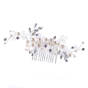 Elegant bridal hair comb with white pearls and sparkling crystals on silver base