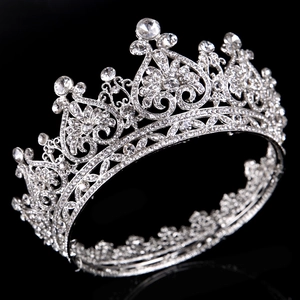Exquisite rhinestone crown with heart patterns on a sleek black background for bridal wear