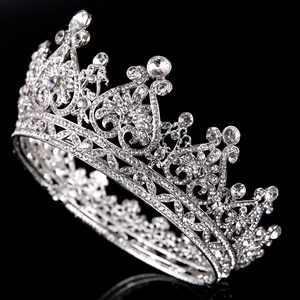 Close-up of luxury silver bridal crown with intricate heart patterns and clear rhinestones