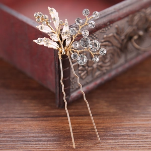 Golden bridal hair comb with white leaf design and sparkling rhinestones for wedding