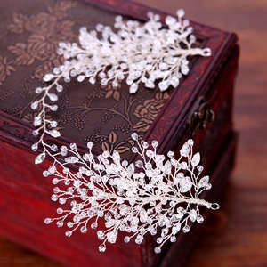 Elegant silver branch bridal hairpiece with crystals and rhinestones on wood box