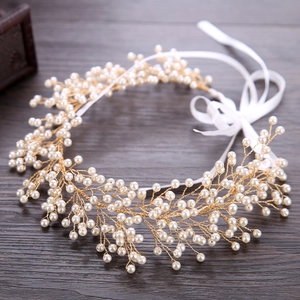 Detailed close-up of handmade gold wire bridal headband with elegant white pearls and ribbon