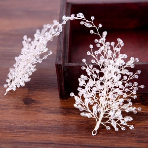 Exquisite bridal crystal hair vine accessory with silver wire and rhinestones on wood