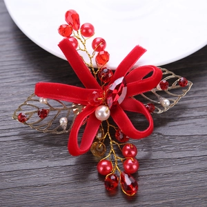 Elegant red velvet bow hair clip with golden leaves and pearls for festive occasions