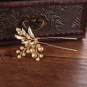 Detail of vintage gold hair comb with yellow rhinestones on a rustic wooden table