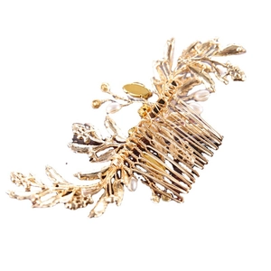 Elegant gold bridal hair comb with decorative metal leaves and white pearls for weddings