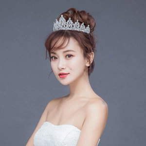 Close-up of sparkling rhinestone bridal crown with silver wavy crystal headpiece detail
